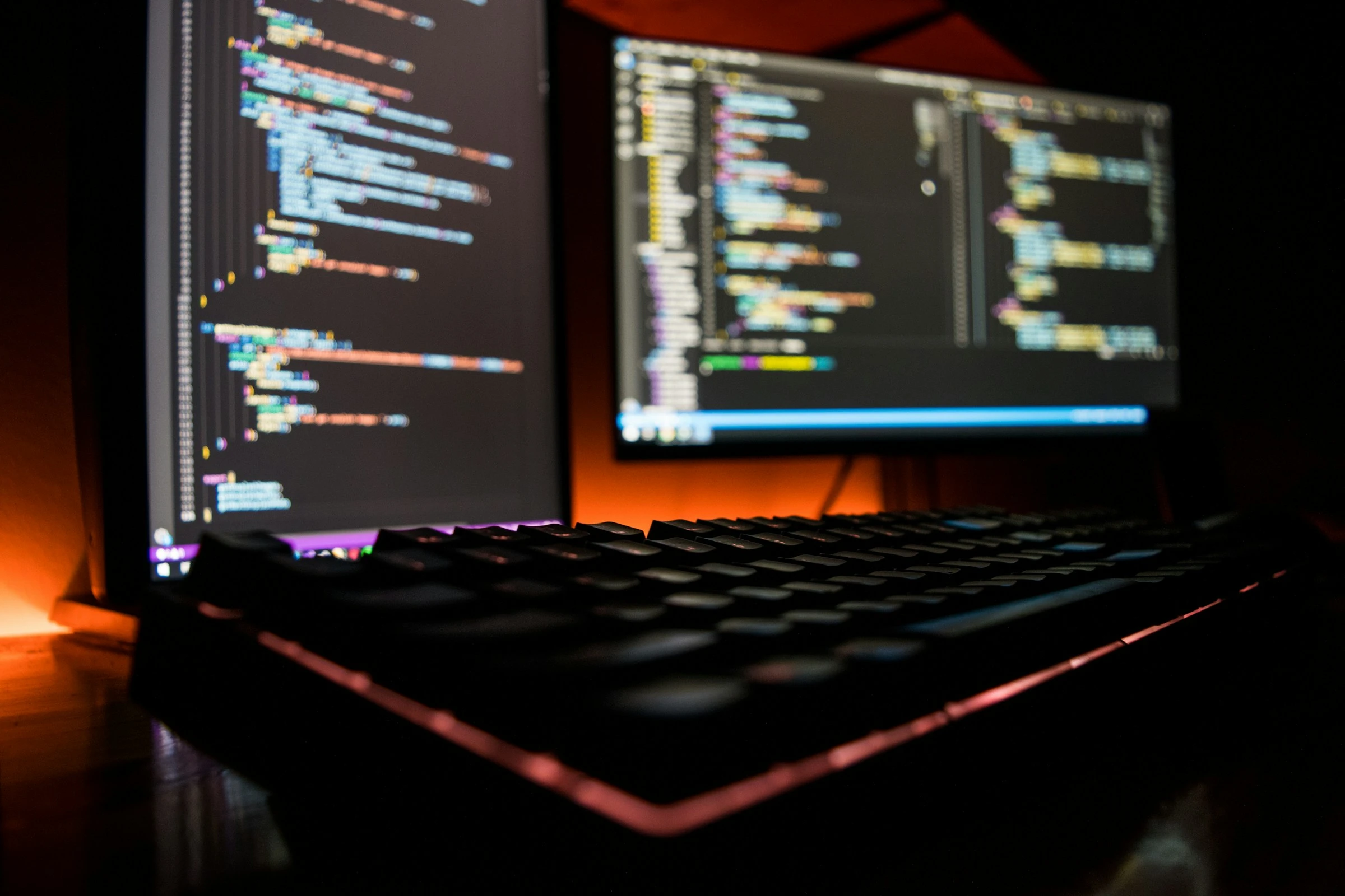 Two code editors and a keyboard