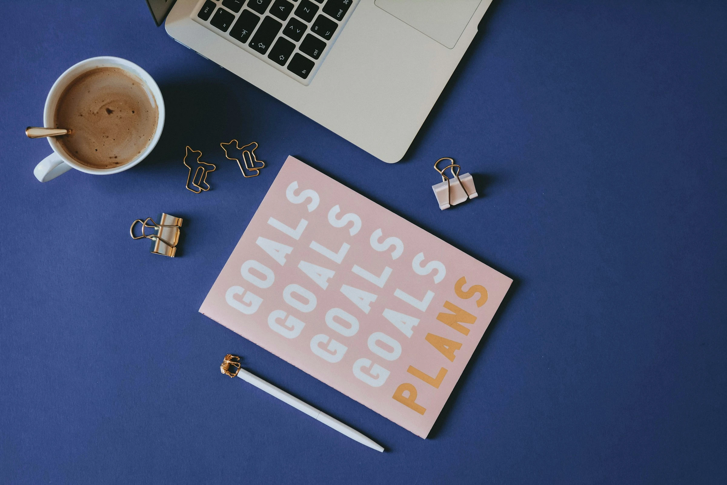 Goals planner with laptop and desk accessories
